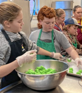Students making green cookies